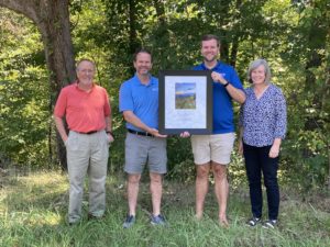 Representatives of the Land for Tomorrow Coalition recognized Rep. Hall as a North Carolina Land and Water Champion at the Piedmont Land Conservancy’s Shoe Buckle tract on the Dan River, which is one of many natural areas across North Carolina that have been funded by the North Carolina Land and Water Fund. The 850-acre tract will provide river access, eventually becoming part of the Mountains-To-Sea Trail. It will also become a key part of the Dan River State Trail. Pictured from left to right: Piedmont Land Conservancy Board President Will Truslow, Piedmont Land Conservancy Executive Director Kevin Redding, Rep. Kyle Hall, and Piedmont Land Conservancy Conservation Planner Palmer McIntyre.